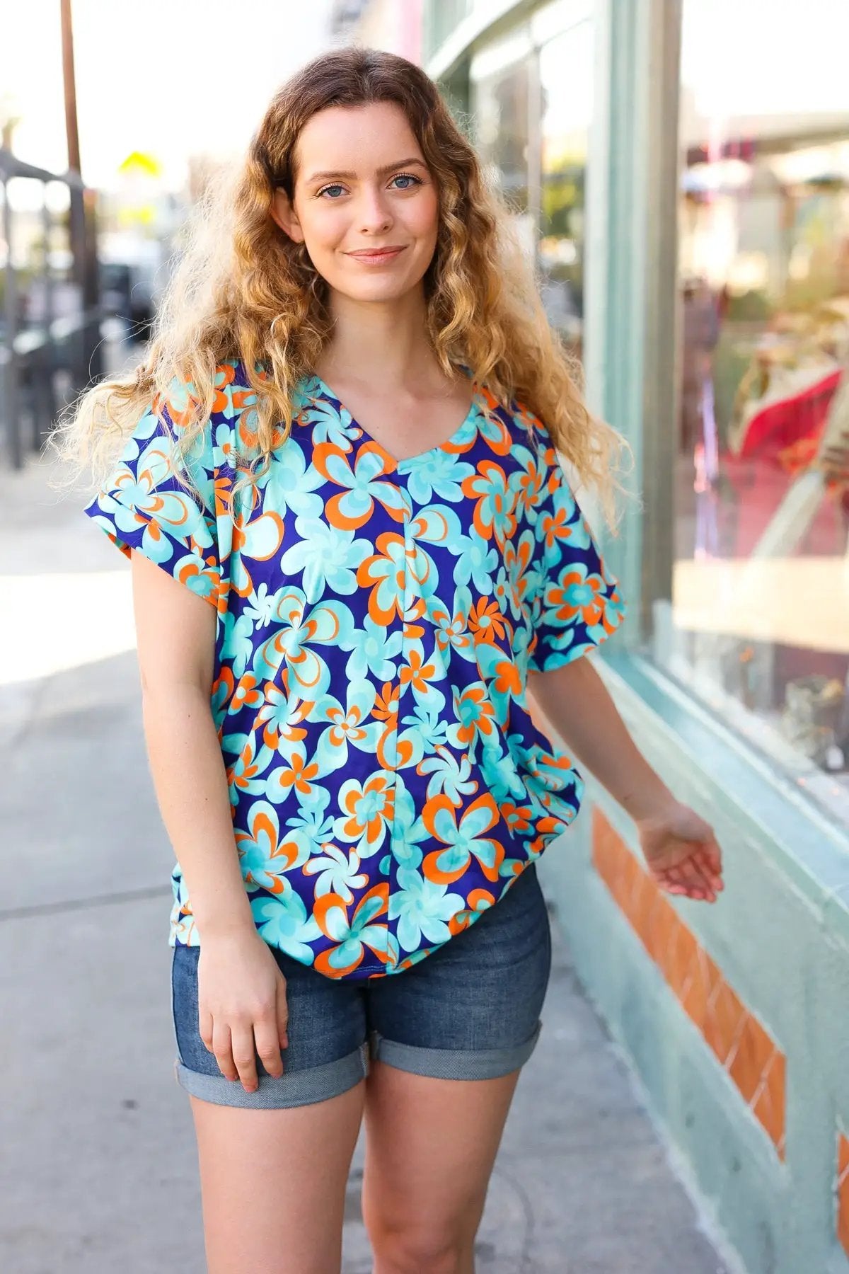 Blue & Orange Flat Floral V Neck Top by Haptics
