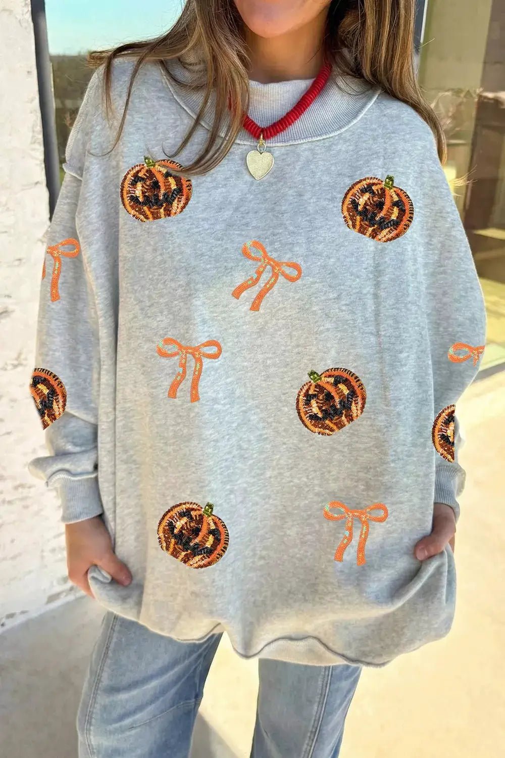 Sequin Pumpkin Face Bow Exposed Seam Halloween Sweatshirt - Bitsy Gypsy Boutique